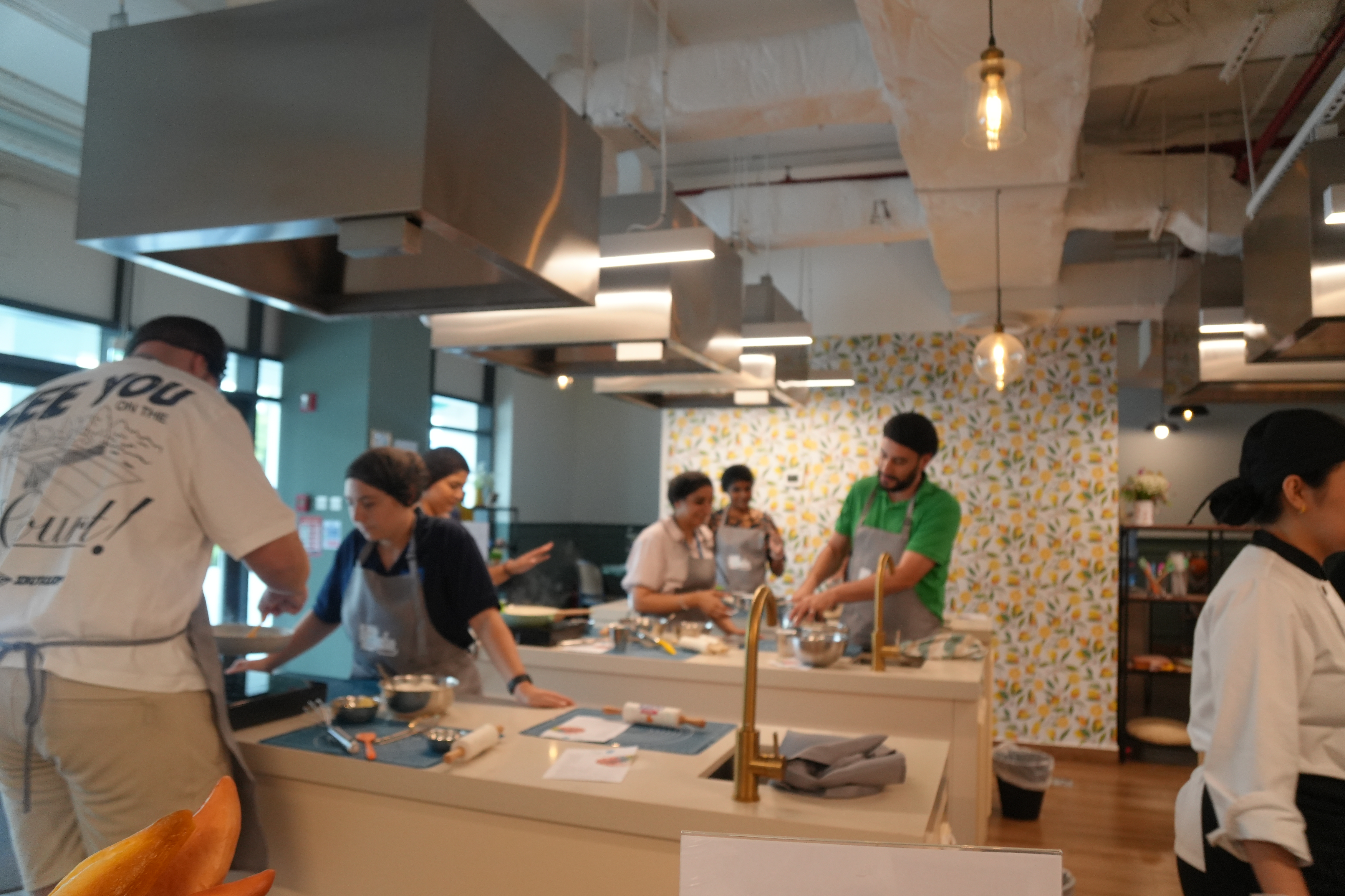 Adults working across the institute's six cooking stations